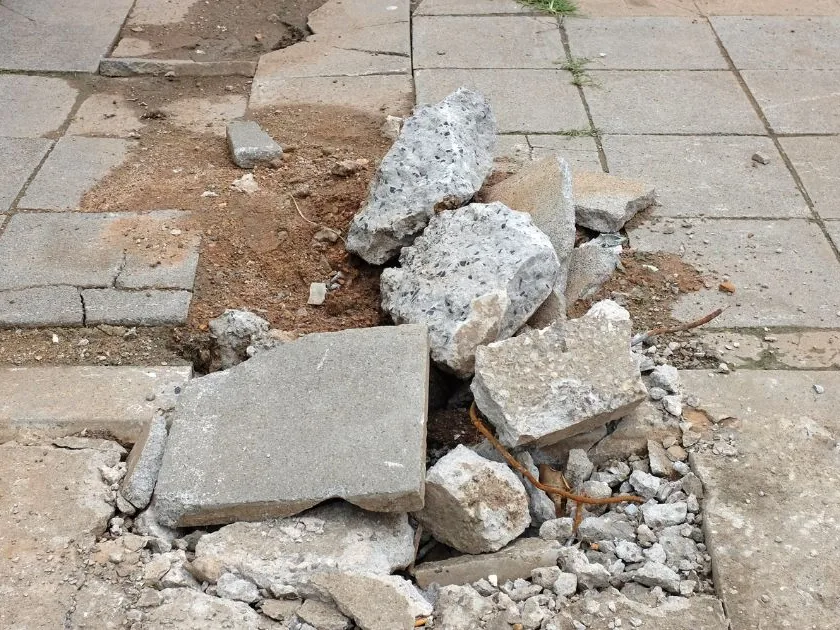 Concrete removal rubble staged in a pile for loading and haul off